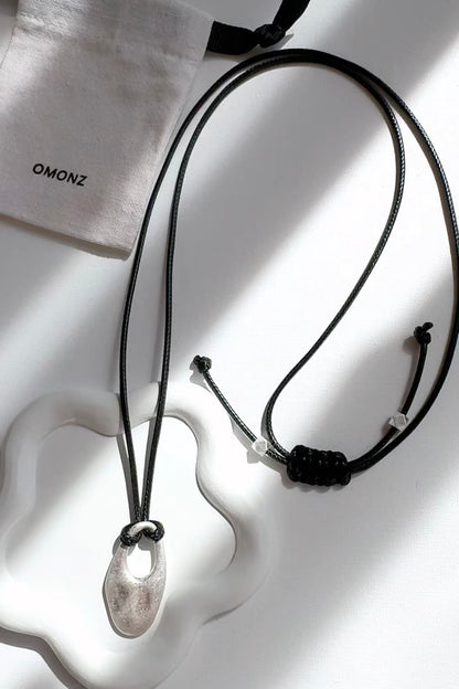 Cord Necklace with Oval Cut Out Pendant
